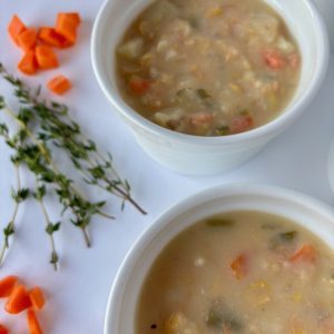 Two small white bowls with salmon chowder.